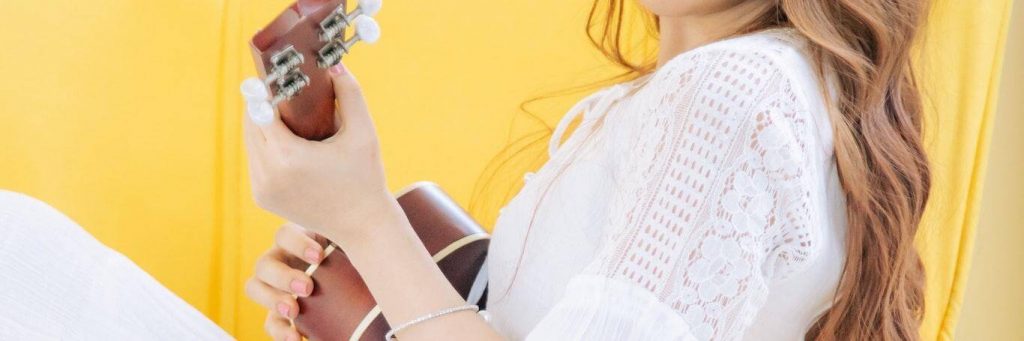 woman practices guitar