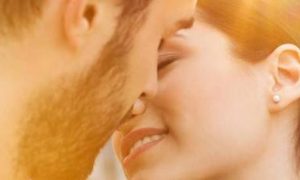 couple about to kiss in sunny sky