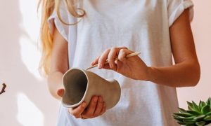 woman holding pot painting