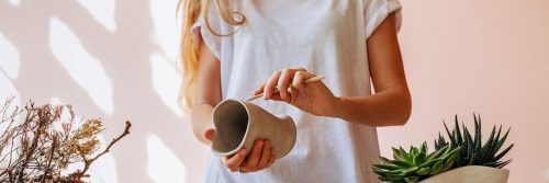woman holding pot painting