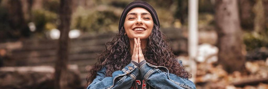 woman breathing smiling gratitude life in park