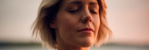 short hair woman eyes closed focuses on breathing meditation