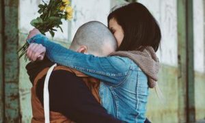 two people hug each other crying