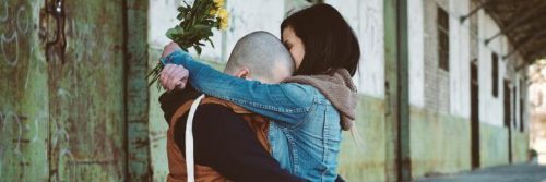 two people hug each other crying