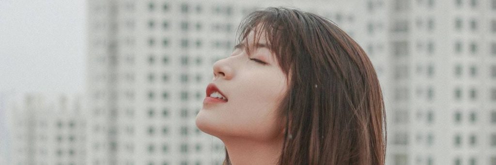 woman closes eyes focuses on breathing building inner peace