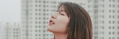 woman closes eyes focuses on breathing building inner peace