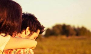 man carries partner walking on field