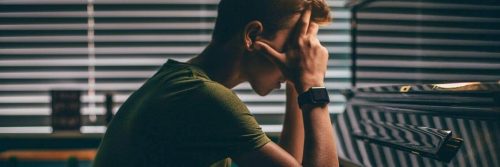 man hands on face distressed