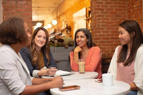 four women having a business meeting
