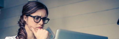 woman focuses on working on laptop in office