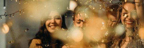 three ladies happily smile celebrate