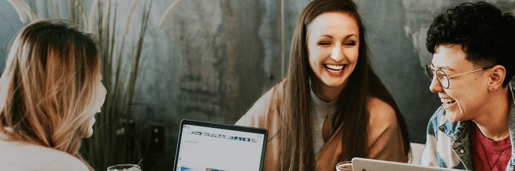 two women one man works in team talking laughing