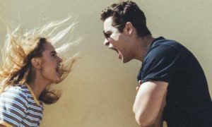 couple stands angrily shouting arguing