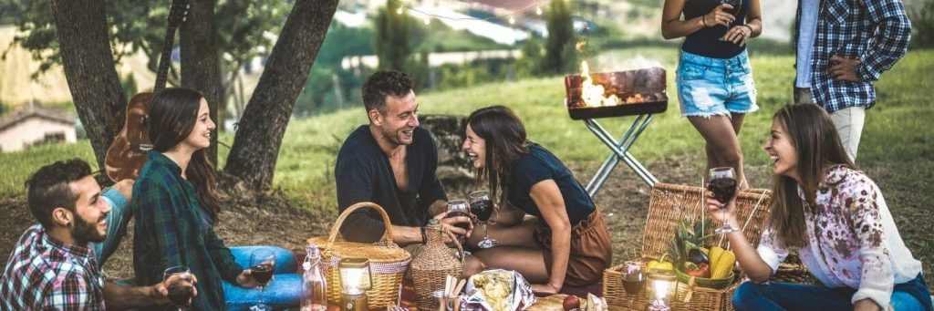 three couples one single woman went on picnic happily talking drinking laughing having bbq