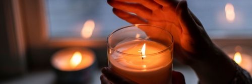 hand cover lighting in small candle cozy environment