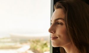 lady standing beside window gratitude enjoy moments