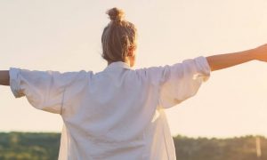 woman facing backward gratitude life in sunny sky