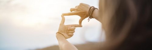 two hands camera shape in shining sky