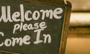 black board signaling welcome please come in