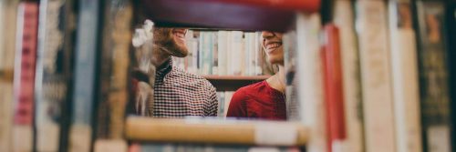 couple faces smiling in bookstore