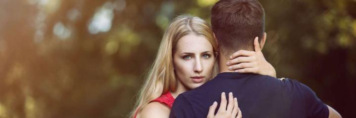 woman hugs boyfriend poses for photos