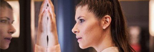 woman looked herself in mirror thinking