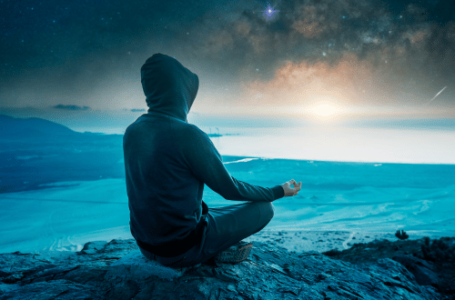 man meditating at sunrise with a mindful approach